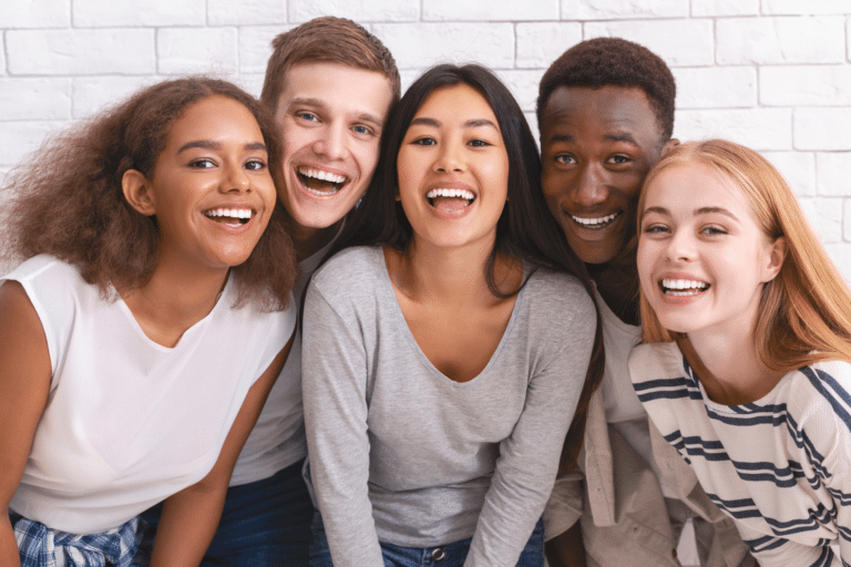Smiling teens learning whether Invisalign may help with overbites in Savannah GA